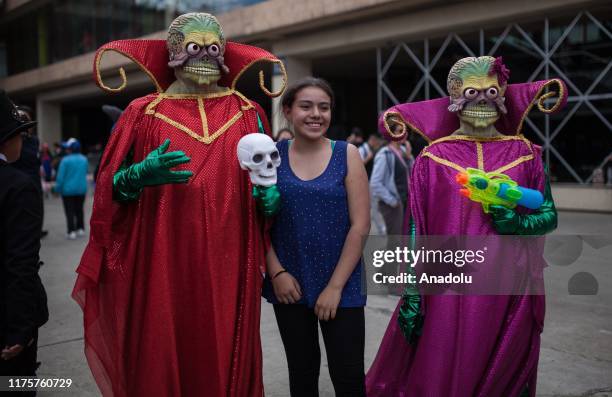 Costumed fans pose inside the Chamber of Commerce of Bogota on SOFÁ on October 13, 2019 in Bogota, Colombia