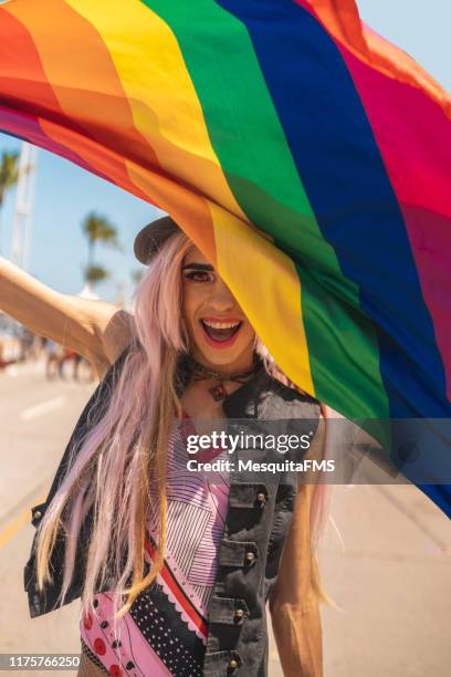 drag queen hiding behind the lgbt flag - homophobia stock pictures, royalty-free photos & images