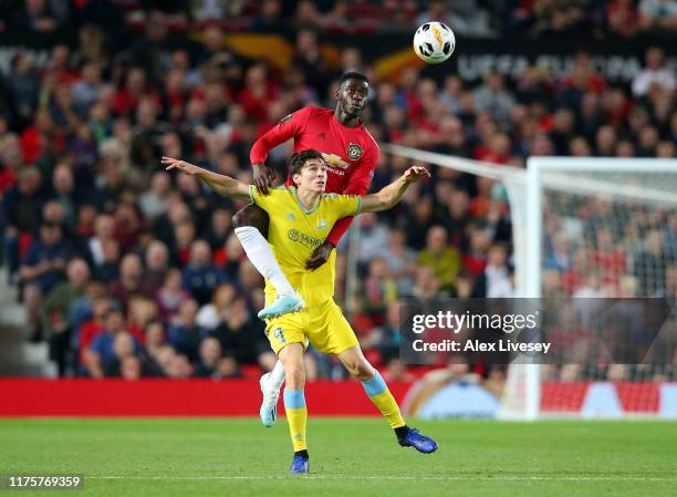 Axel Tuanzebe of Manchester United and Dorin Rotariu of Asanta compete for the ball during the UEFA Europa League group L match between Manchester...