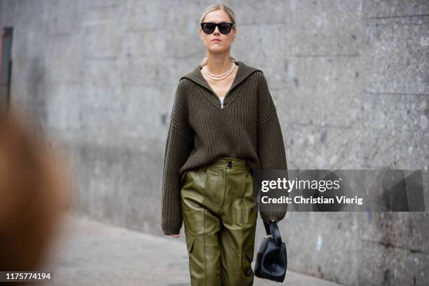 Linda Tol is seen wearing olive green pants, knit with zipper, black pants outside the Max Mara show during Milan Fashion Week Spring/Summer 2020 on...