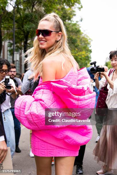 Chiara Ferragni, wearing pink oversize jacket and Oakley sunglass, poses outside the Fendi show during Milan Fashion Week Spring/Summer 2020 on...