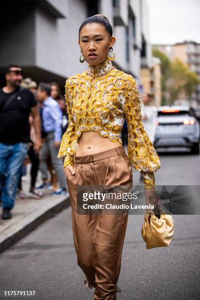 Jaime Xie, wearing brown Max Mara pants, Zimmerman top and row bag, poses outside the Max Mara show during Milan Fashion Week Spring/Summer 2020 on...