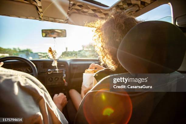 backlit sunset view from the rear car seat - roadtrip imagens e fotografias de stock