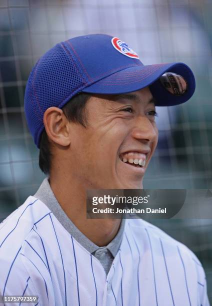 Japanese tennis star Kei Nishikori prepares to throw a ceremonial first pitch before the Chicago Cubs take on the St. Louis Cardinals at Wrigley...