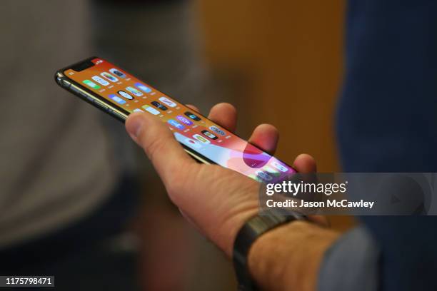 Customers look at the latest iPhone models at Apple Store on September 20, 2019 in Sydney, Australia. Apple's latest iPhone 11 features dual rear...