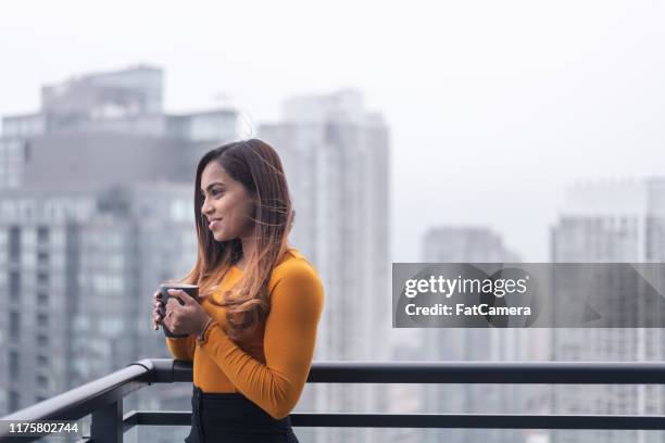 beautiful woman looks at urban skyline - toronto coffee stock pictures, royalty-free photos & images