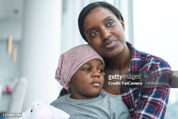 supportive mother holds child with cancer - cancer illness stock pictures, royalty-free photos & images