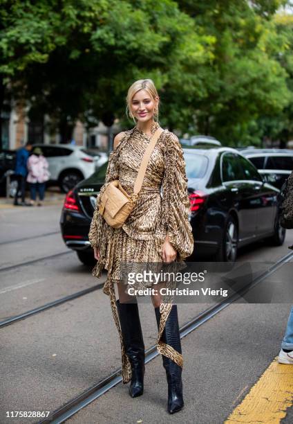 Mandy Bork seen wearing dress with animal print, beige Fendi bag outside the Fendi show during Milan Fashion Week Spring/Summer 2020 on September 19,...