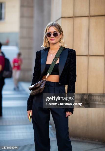 Anne Laure Mais wearing black cropped top, Louis Vuitton bag, blazer, pants seen outside Attico during Milan Fashion Week Spring/Summer 2020 on...