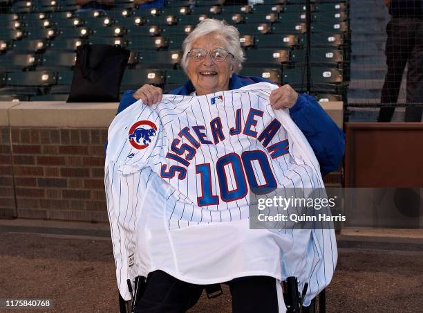 Dolores Schmidt "Sister Jean" of the Loyola Ramblers men's basketball team poses with a Cubs jersey given to her by manager Joe Maddon before the...