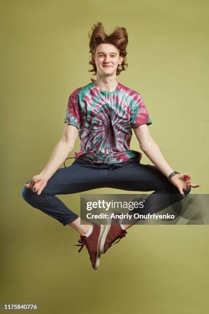 young adult man jumping for joy - meditation levitation stock pictures, royalty-free photos & images