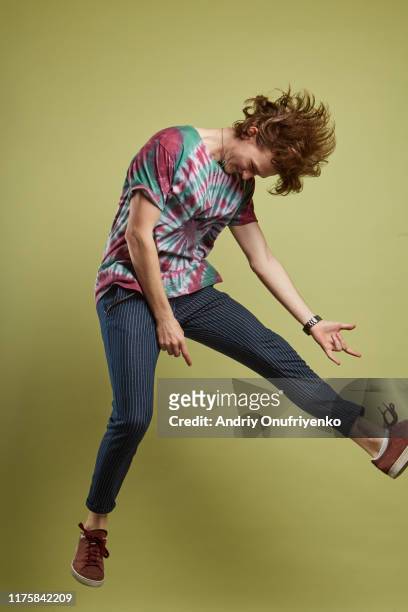 young adult man jumping for joy - rock object stock pictures, royalty-free photos & images