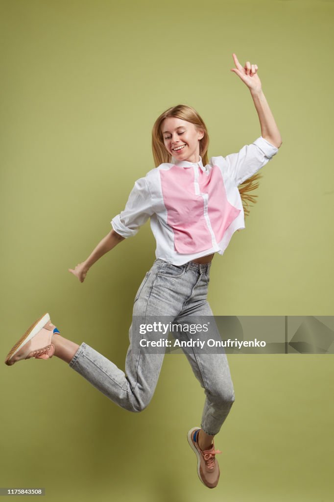 Young adult female jumping for joy