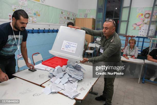 Staff members of the Independent High Authority For The Elections , count ballots of the second round of Tunisia presidential election between...