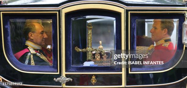 The state regalia, The Sword of State, Imperial State Crown and the Cap of Maintainance, are transferred in the Queen Alexandra's State Coach from...