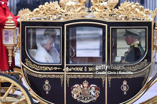 Queen Elizabeth II, Prince Charles, Prince of Wales and Camilla, Duchess of Cornwall are transported in a carriage along The Mall ahead of the State...