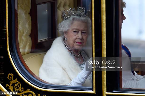 Queen Elizabeth II travels by carriage along The Mall ahead of the State Opening of Parliament at the Palace of Westminster on October 14, 2019 in...