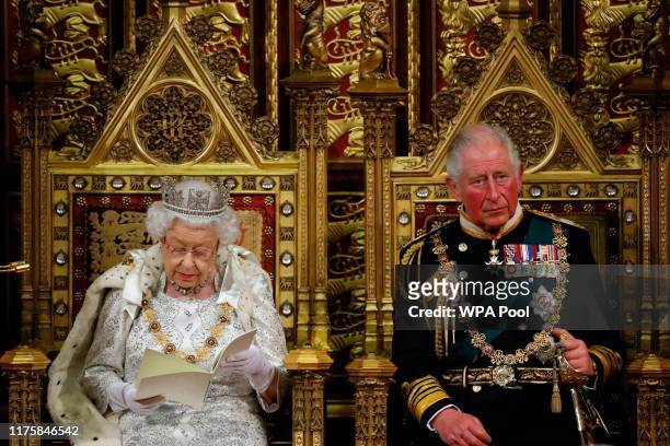 Queen Elizabeth II reads the Queen's Speech on the The Sovereign's Throne in the House of Lords next to Prince Charles, Prince of Wales during the...
