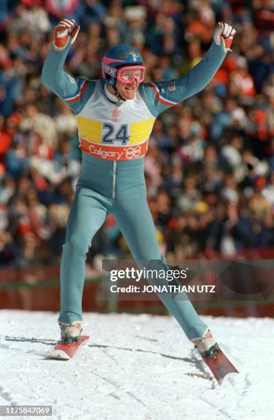 Britain's first ever Olympic ski jumper Eddie Edwards waves to the cheering crowd after completing his first safe jump during the 90m event 23...