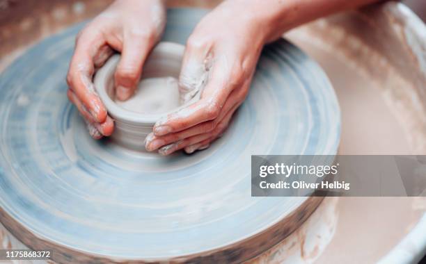 potters hands on wheel - pottery making stock-fotos und bilder