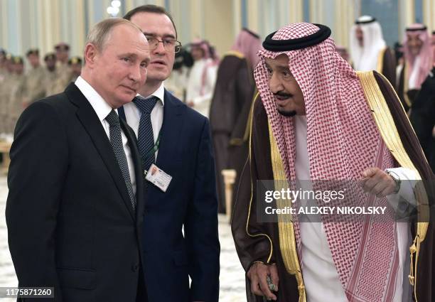 Russian President Vladimir Putin and Saudi Arabia's King Salman attend the official welcome ceremony in Riyadh, Saudi Arabia, on October 14, 2019.