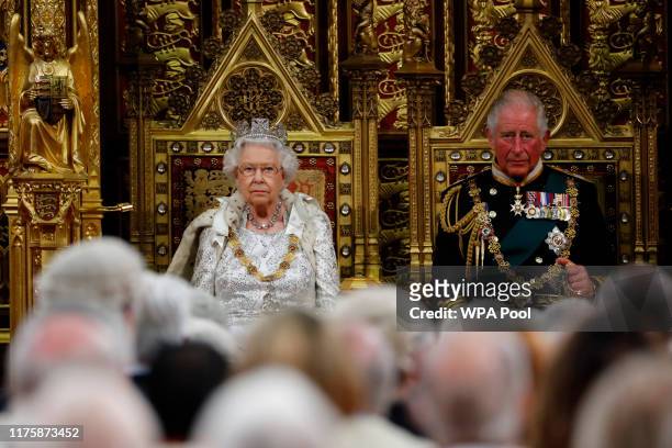 Britain's Queen Elizabeth II takes her seat on the The Sovereign's Throne in the House of Lords next to Prince Charles, Prince of Wales before...