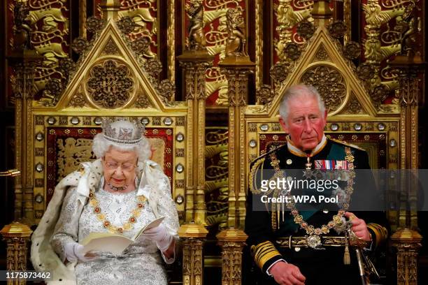 Britain's Queen Elizabeth II reads the Queen's Speech on the The Sovereign's Throne in the House of Lords next to Prince Charles, Prince of Wales...