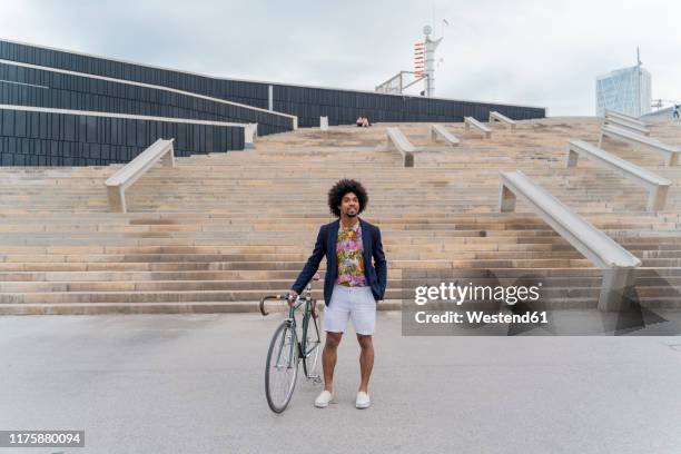 stylish man with bicycle standing at stairs - casual menswear stock pictures, royalty-free photos & images