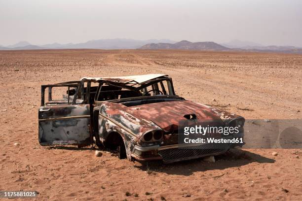 abandoned car at the namibe desert, namibe, angola - abandoned car stock pictures, royalty-free photos & images