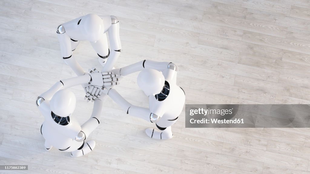 Rendering of three robots stacking hands