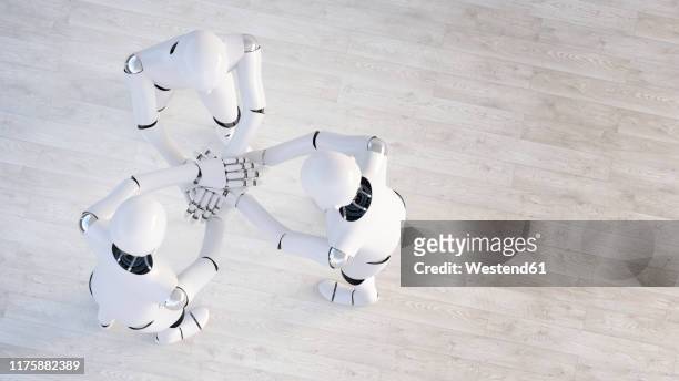 rendering of three robots stacking hands - robotic arm stock illustrations
