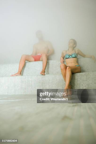 couple relaxing in a hammam - turks bad stockfoto's en -beelden