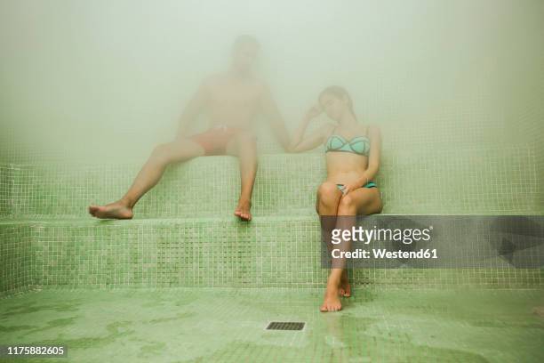 couple relaxing in a hammam - turks bad stockfoto's en -beelden