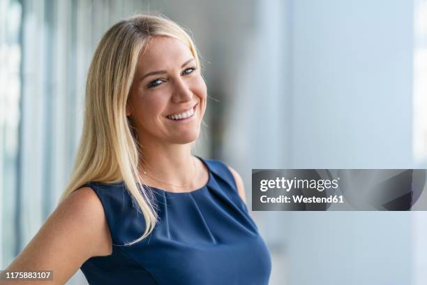 portrait of smiling blond businesswoman in summer - sleeveless stock pictures, royalty-free photos & images