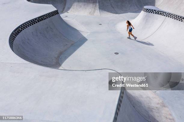 young woman inline skating in skatepark - skateboard park stock pictures, royalty-free photos & images