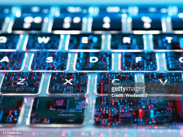 double exposure of a laptop computer showing electronic components under the keyboard - digitization stockfoto's en -beelden