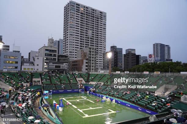 Spectators react after the announcement of the cancellation of all the matches during day five of the Toray Pan Pacific Open at Utsubo Tennis Cent on...