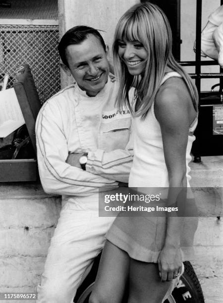 Bruce McLaren with female admirer in the pits, 1967 Italian Grand Prix.