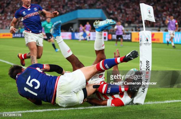 Kotaro Matsushima of Japan touches down for a try under pressure from Vasily Artemyev of Russia, but it is disallowed during the Rugby World Cup 2019...