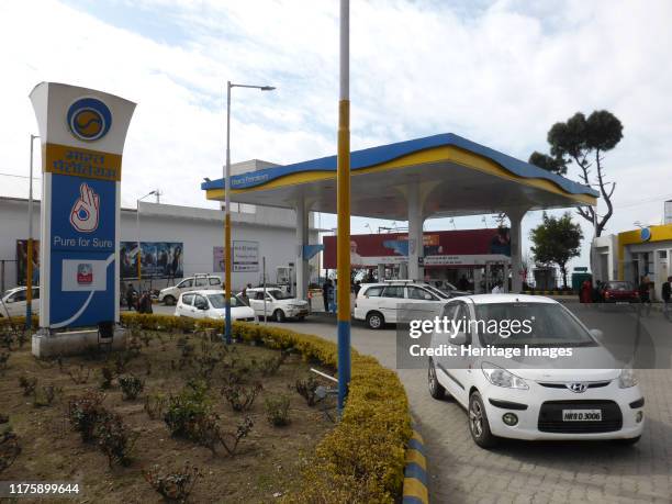 Cars re-fuelling at petrol station Dharamshala Himachal Pradesh.