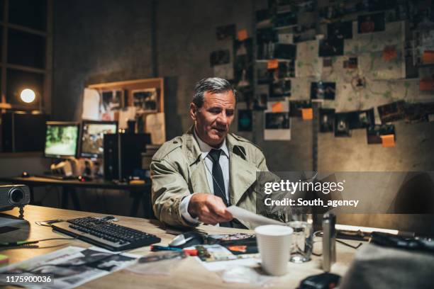 detective working alone in office - killing stock pictures, royalty-free photos & images