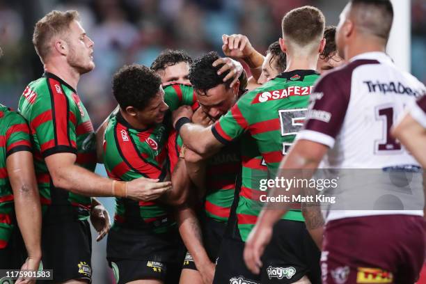 John Sutton of the Rabbitohs celebrates with team mates after scoring a try during the NRL Semi Final match between the South Sydney Rabbitohs and...