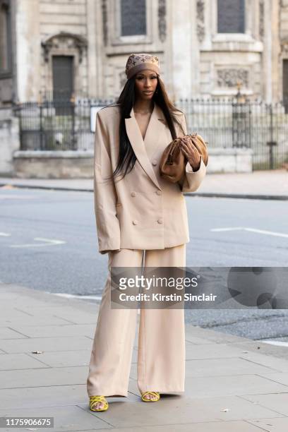 Designer and digital Influencer Rachel Michelle wears a Louis Vuitton scarf and an R.Michel'le the label suit, bag and shoes during London Fashion...