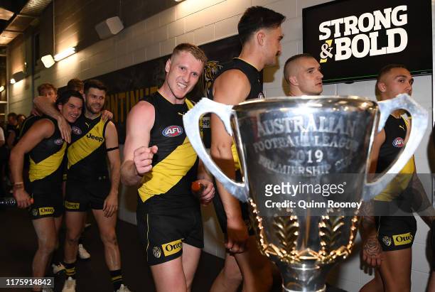 Josh Caddy of the Tigers looks at the Premiership Trophy after winning the AFL Preliminary Final match between the Richmond Tigers and the Geelong...