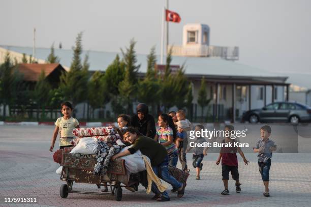 Syrian family carries their furniture at the Boynuyogun refugee camp on September 16, 2019 in Hatay, Turkey. Turkey’s president, Recep Tayyip...