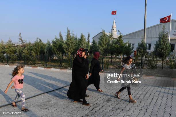 Syrian women with children walk through the Boynuyogun refugee camp on September 16, 2019 in Hatay, Turkey. Turkey’s president, Recep Tayyip Erdogan,...