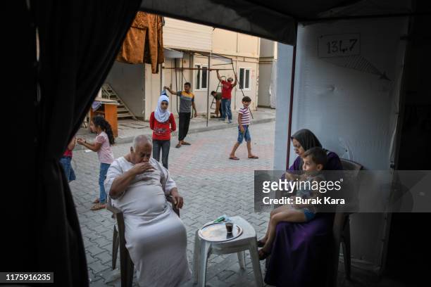Syrian family sits in front of their home in the Boynuyogun refugee camp on September 16, 2019 in Hatay, Turkey. Turkey’s president, Recep Tayyip...