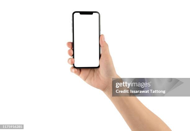 close up hand hold phone isolated on white, mock-up smartphone white color blank screen - menselijke hand stockfoto's en -beelden