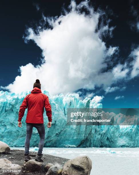 watching the perito moreno glacier in argentina - global climate change stock pictures, royalty-free photos & images