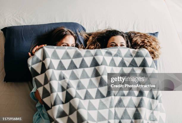 teenage girls having fun in bed - sister stock pictures, royalty-free photos & images